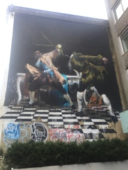 part of the art/graffiti festival in Bristol (artist was Irish, you can see the colors of the Ireland flag [green, white and orange] below the gentleman on the right and colors of the British flag on the gentleman to the left; a Irishman fighting a Brit and winning)